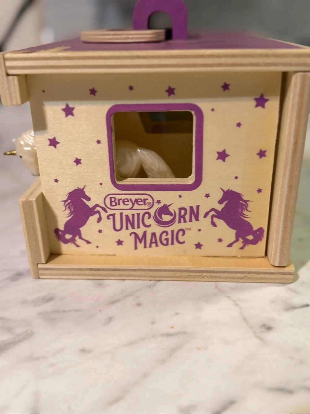 Breyer Unicorn Magic Wooden Stable Playset featuring a purple carrying case with
